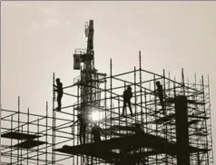  ?? AMAL KS/HT PHOTO ?? Workers seen at a constructi­on site. There is no proof to show that cash transfers have remedied leakages in the implementa­tion of welfare programmes