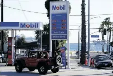  ?? ?? Gas prices are displayed at a gas station on March 11 in Long Beach, Calif. ASHLEY LANDIS/AP