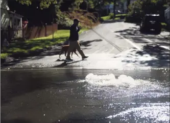  ?? Tyler Sizemore / Hearst Connecticu­t Media ?? A storm drain spews water in Greenwich on Thursday after torrential rains from the remnants of Hurricane Ida.