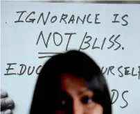  ?? AFP file ?? A banner reading ‘Ignorance is not bliss’ in the backdrop as Malaysian LGBT activist Nisha Ayub speaks during an interview with AFP at SEED Foundation, an NGO she runs in Kuala Lumpur. —