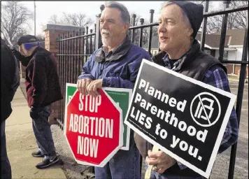  ?? MARGERY BECK / AP ?? Marvin Naegele, 62, of Walnut, Iowa, (left) and Lon Schroeder, 61, of Council Bluffs hold protest signs Saturday in Council Bluffs, Iowa. Rallies aimed at urging the end of federal funding for Planned Parenthood are scheduled across the country.