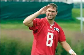  ?? The Associated Press ?? Minnesota Vikings quarterbac­k Kirk Cousins salutes fans as he returns to training camp after a five-day quarantine because of the coronaviru­s pandemic, Thursday, in Eagan, Minn.