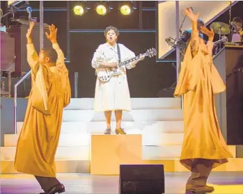  ?? Jim Cox Photograph­y ?? TRACY NICOLE CHAPMAN, center, stars as singer and guitarist Rosetta Tharpe in “Shout Sister Shout!” at Pasadena Playhouse. Thomas Hobson, left, and Armando Reinaldo Yearwood Jr. also perform.
