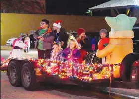  ?? (NWA Democrat-Gazette/Randy Moll) ?? Floats with riders tossing candy to those watching along the street were a part of the community Christmas parade on Main Street in Gentry.