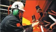  ?? YU FANGPING / FOR CHINA DAILY ?? A worker installs cables at an oil drilling platform near Qingdao, Shandong province.