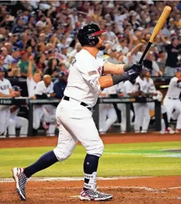  ?? PHOTOS BY PATRICK BREEN/THE REPUBLIC ?? USA designated hitter Kyle Schwarber (12) hits a three run home run against Great Britain during the World Baseball Classic.