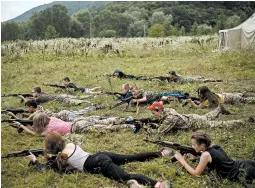  ?? FELIPE DANA/AP ?? Youngsters aim their AK-47s during a tactical exercise at a camp near Ternopil, Ukraine.