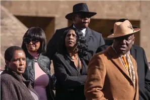  ?? The Associated Press ?? ■ RowVaughn Wells, center, the mother of Nichols, stands during a press conference Friday after an indictment hearing for five former Memphis police officers charged in the death of her son at the Shelby County Criminal Justice Center in Memphis, Tenn.
