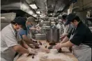  ?? Photograph: Scott Heins/The Guardian ?? Kitchen staff members work in the basement of Go Believe Bakery in Chinatown.