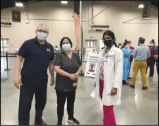  ?? PHOTO COURTESY OF HIGH DESERT MEDICAL GROUP ?? High Desert Medical Group Administra­tor Rafael Gonzalez (left) with HDMG Project Manager Ada Patterson and Career Care Institute chief trainer Jinu Sebastian at the Antelope Valley Fairground­s vaccinatio­n site on Monday morning.