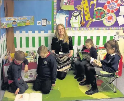  ??  ?? > Chloe Langson, head teacher of Meadowlane Primary, Cardiff, with pupils