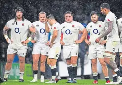  ??  ?? The England players were left dejected at Twickenham