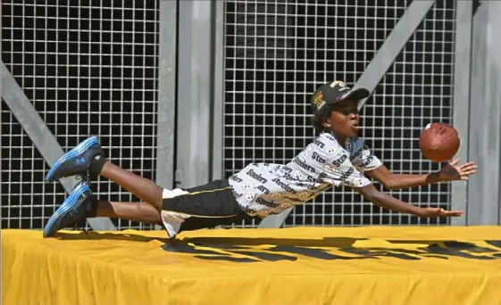  ?? Jack Myer/Post-Gazette photos ?? Top: Axel Bane Slade, 9, of Albuquerqu­e, N.M., dives for the ball during one of the activities at Steelers Fest on Saturday outside Heinz Field on the North Shore.