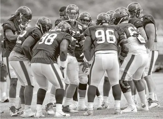  ?? Brett Coomer / Houston Chronicle ?? Defensive end J.J. Watt, center, gathers the defensive linemen together during a training camp practice. Watt is the undisputed leader on and off the field.