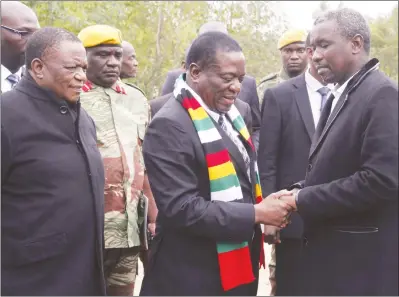  ?? — (Picture by John Manzongo) ?? President Mnangagwa consoles Mr Kudakwashe Tagwirei while flanked by Vice President Constantin­o Chiwenga before the burial of the businessma­n’s father, Sekuru Phineas Tagwirei, in Shurugwi yesterday.