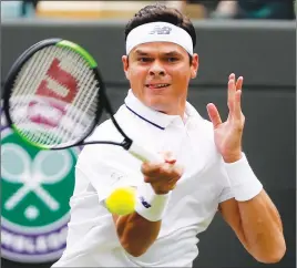  ?? AP PHOTO ?? Milos Raonic returns a shot during his match yesterday at Wimbledon.