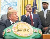  ?? SUSAN WALSH/THE ASSOCIATED PRESS ?? President Donald Trump and Lennox Lewis, right, look on as Sylvester Stallone gestures during Johnson’s pardon Thursday.