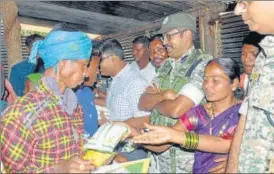  ?? ANI ?? Security officials distributi­ng ration at Bodli village of Bastar district, Chhattisga­rh on Monday. n