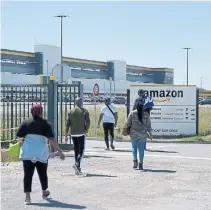  ?? ERIC PIERMONT AFP VIA GETTY IMAGES ?? Workers arrive at Amazon France’s Brétigny-sur-Orge centre on Tuesday. French courts ruled last month Amazon hadn’t done enough to protect its workers from COVID-19 and the company shut its French warehouses as a result.