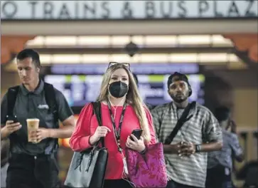  ?? Irfan Khan Los Angeles Times ?? COMMUTERS at Union Station in Los Angeles last month amid warnings about a new Omicron subvariant. Omicron’s supposed mildness may be largely due to increasing population immunity and better treatments.