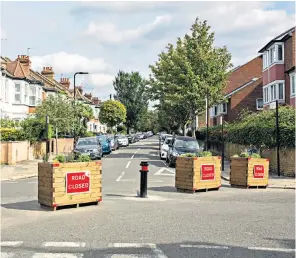  ?? ?? Road bumps: Low Traffic Neighbourh­ood scheme in Ealing, west London, top; Andrew Gilligan, the PM’S transport adviser, below, right