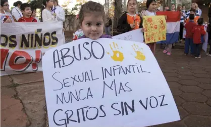  ?? Photograph: Peter Prengaman/AP ?? A child holds a sign that reads in Spanish ‘Child sexual abuse never again, screams without voice,’ at a demonstrat­ion in Ciudad del Este, Paraguay, in 2015.