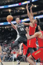  ?? JOHN BAZEMORE/ASSOCIATED PRESS ?? San Antonio Spurs forward DeMar DeRozan, left, drives against Atlanta Hawks forward De’Andre Hunter while battling it out on Tuesday.