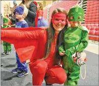  ??  ?? Melissa Coston and her son, Jeremiah, are dressed as Owlette and Gekko from the television show PJ Masks.
