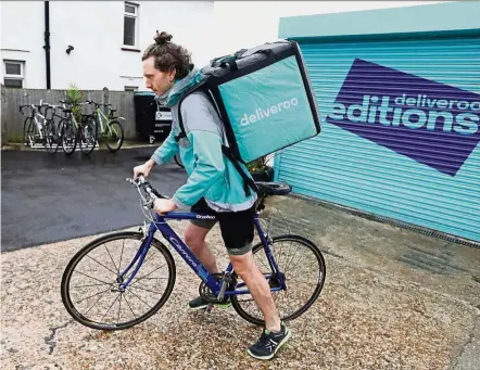  ??  ?? On expansion path: A delivery cyclist sets off from a Deliveroo Editions field kitchen in Hove, UK. Deliveroo is rapidly expanding to better compete with Uber, Amazon.com Inc and others in the crowded restaurant-delivery market.
