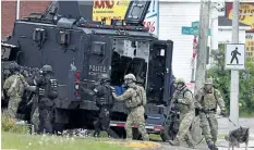  ?? THE CANADIAN PRESS FILES ?? Emergency response officers enter a residence in Moncton, N. B. on June 5, 2014. A sentencing hearing was held in New Brunswick Thursday for the RCMP after the national police force was convicted of failing to properly equip and train its members for a...