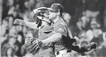  ?? JIM YOUNG/USA TODAY SPORTS ?? Rockies relief pitcher Scott Oberg celebrates with teammate Tony Wolters (left) after defeating the Cubs in the NL wild card playoff.