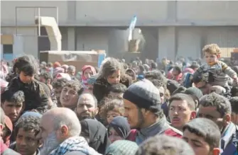  ?? SANA ?? A photo released by the Syrian official news agency SANA shows Syrian civilians with their belongings as they flee from fighting between the Syrian government forces and rebels near Hamouria in eastern Ghouta, a suburb of Damascus. Airstrikes on Friday...