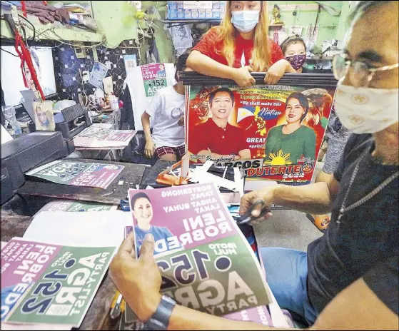  ?? KRIZJOHN ROSALES ?? A Manila shop offering printing services prepares campaign materials for candidates in the May elections yesterday.