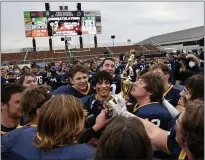  ?? PAUL DICICCO — FOR THE NEWS-HERALD ?? Kirtland’s Liam Powers kisses the state championsh­ip trophy after the Hornets’ 38-0 win over Ironton during the Division V state final Nov. 21 in Massillon.