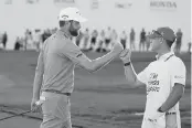  ?? LYNNE SLADKY AP ?? Chris Kirk fist-bumps caddie Michael Cromie after his 66 Saturday at the Honda Classic in Palm Beach Gardens.