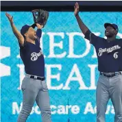  ?? WILFREDO LEE/ ASSOCIATED PRESS ?? Milwaukee’s Ryan Braun, left, and Lorenzo Cain celebrate after the Brewers’ victory over Miami on Thursday afternoon. Braun had a tworun homer to key the triumph.