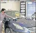  ?? ANI FILE ?? A worker sanitize a car in an open Toyota showroom in Lucknow.