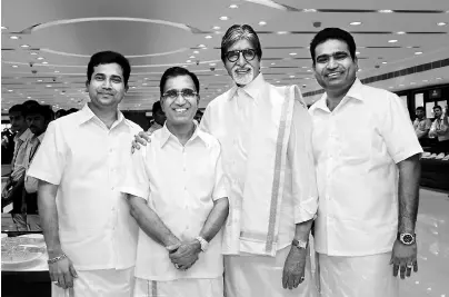 ??  ?? STAR-STUDDED: T S Kalyanaram­an ( second from left) and his two sons with brand ambassador Amitabh Bachchan
