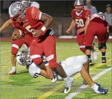  ?? PETE BANNANDIGI­TAL FIRST MEDIA ?? West Chester East running back Pierre Marchant (5) runs into Pottstown’s Nehemiah Figueroa in the second quarter.