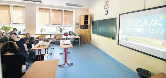  ?? AP ?? Striking teachers watch television reports from the nationwide protest action in the teacher’s room at primary school Number 68 in Warsaw, Poland, on Monday, April 8. Majority of Poland’s school and kindergart­en teachers went on strike after talks about their payment with the government failed.