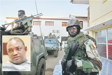  ??  ?? Members of the regional ECOWAS force keep guard at Presidence palace in Banjul, Gambia. (Inset) Adama Barrow. — Reuters photo