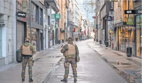 ?? STEPHANIE LECOCQ, EUROPEAN PRESSPHOTO AGENCY ?? Belgian soldiers patrol in empty Rue Neuve, the busiest shopping street in Brussels, after the terror alert was elevated.