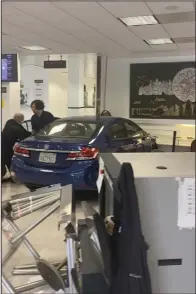  ?? (AP/Sergii Molchanov) ?? A man gets out of his car after crashing into the lobby of the Chinese Consulate in San Francisco on Monday.