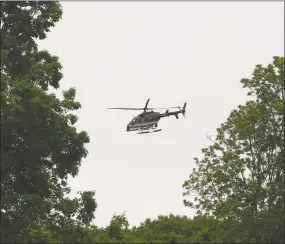  ?? Tyler Sizemore / Hearst Connecticu­t Media ?? A New York State Police helicopter aids in the search for missing person Jennifer Dulos at Waveny Park in New Canaan on May 29.