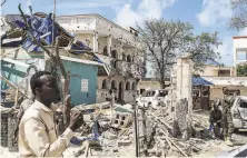  ?? Agence France Press / Tribune News Service ?? A man passes rubble of a hotel in Kismayo, Somalia, in 2019, a day after 26 people were killed in an attack by alShabab.