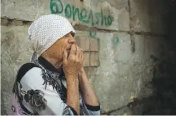  ?? AP PHOTO/GEORGE IVANCHENKO ?? An elderly Ukrainian woman looks on after Russian shelling Wednesday in Mykolaiv, Ukraine.