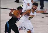  ?? AP PHOTO — MARK J. TERRILL ?? Los Angeles Clippers guard Patrick Beverley (21) is pressured by Denver Nuggets guard Jamal Murray (27) as he drives with the ball during the second half of an NBA conference semifinal playoff basketball game