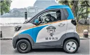  ?? ?? Even police in Liuzhou use electric vehicles, which are often customised with stickers on their sides