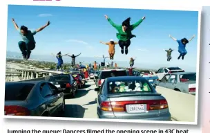  ??  ?? Jumping the queue: Dancers filmed the opening scene in 43C heat