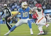  ?? Ashley Landis Associated Press ?? JUSTIN HERBERT and the Chargers took Nick Bolton and the Chiefs to overtime in their last game.